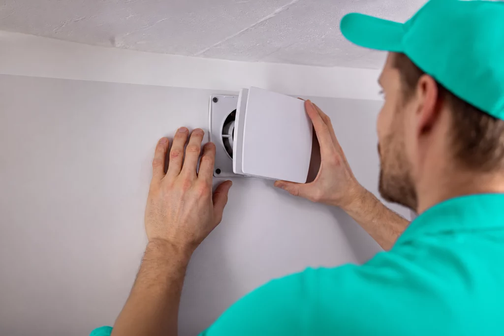 Technician installing a vent for an air conditioning system